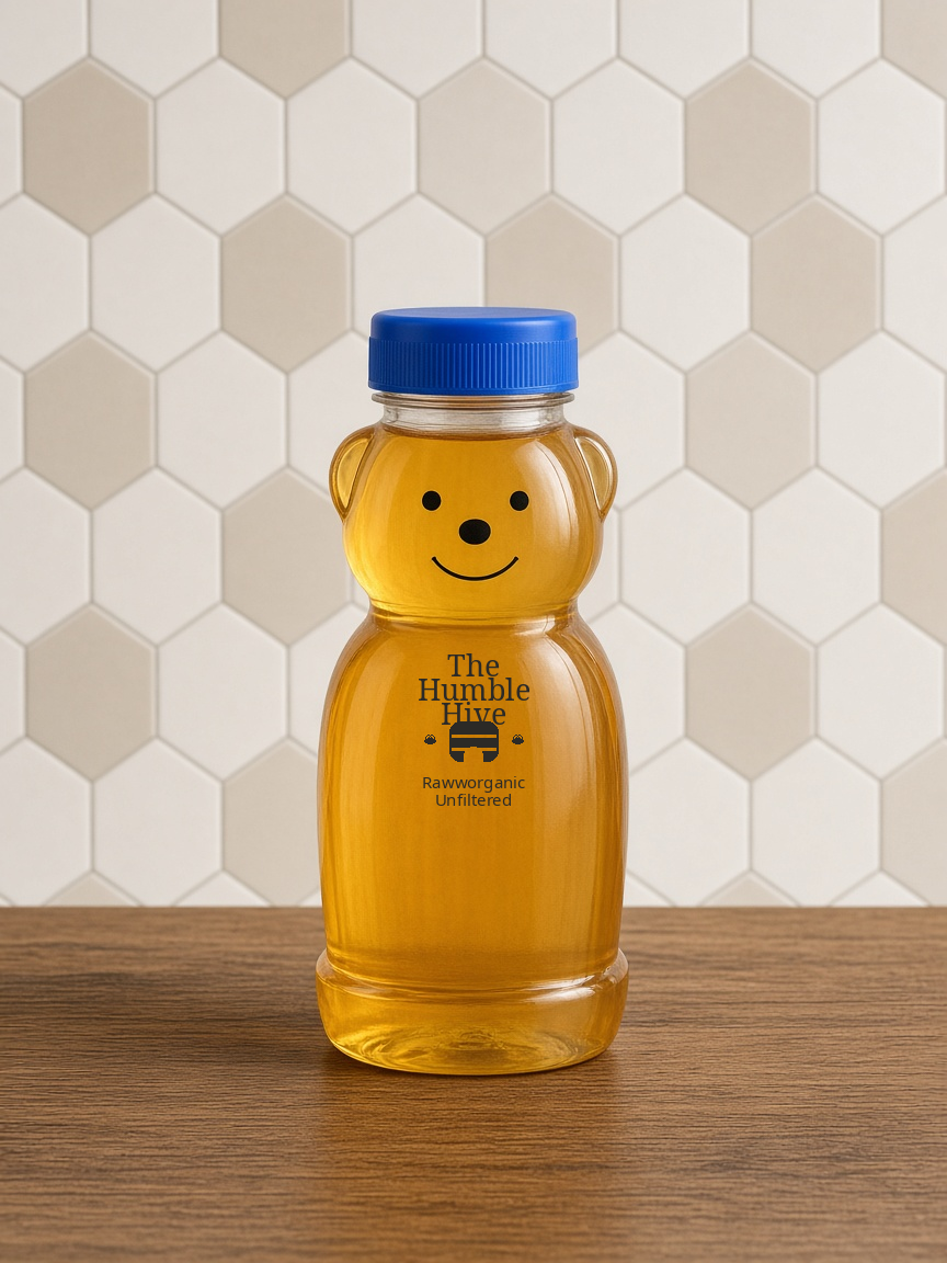 12-ounce The Humble Hive bear bottle with a blue lid, filled with liquid honey